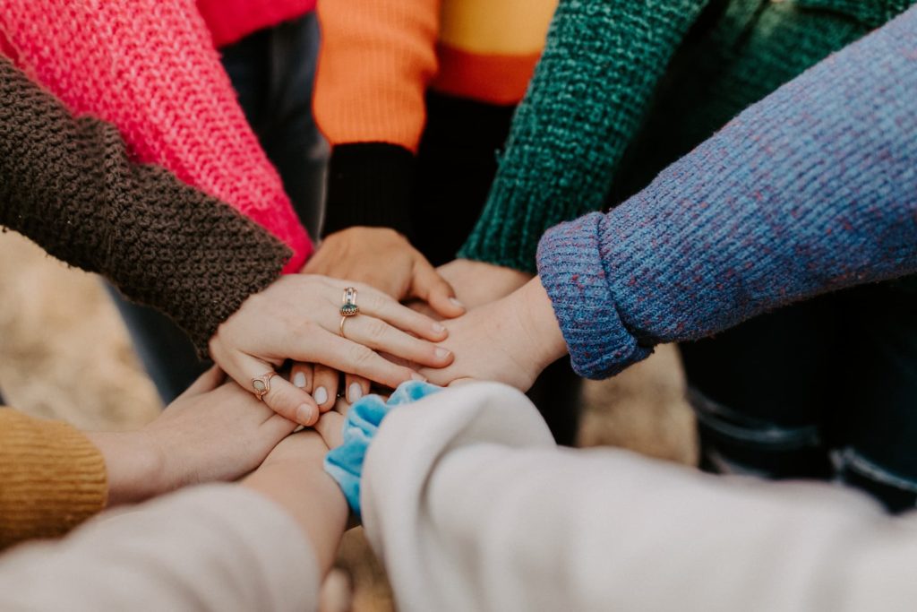 Various different hands stacked together